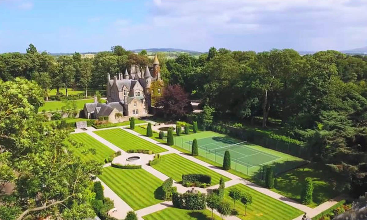 An aerial photo of Carlowrie Castle surrounded by greenery. An aerial photo of Carlowrie Castle surrounded by greenery.